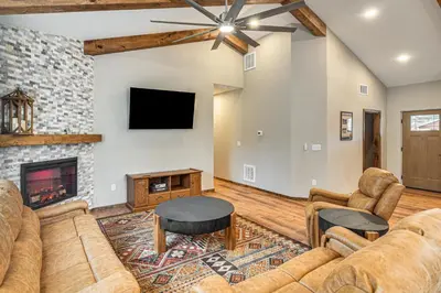 a living room with couches and a fireplace at Hike and Fish Group Getaway with Hot Tub in Bailey! in Bailey