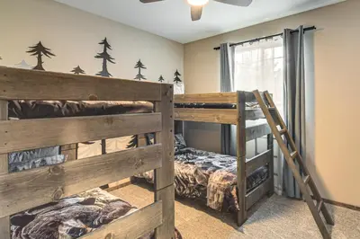 a bedroom with two bunk beds and a window at Hike and Fish Group Getaway with Hot Tub in Bailey! in Bailey