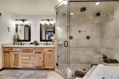 a bathroom with two sinks and a shower at Serene Nordic-Inspired Lakeside Retreat with Panoramic Mountain Views Near Breckenridge, Dillon, Colorado in Dillon