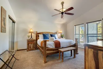 a bedroom with a bed and a ceiling fan at Serene Nordic-Inspired Lakeside Retreat with Panoramic Mountain Views Near Breckenridge, Dillon, Colorado in Dillon