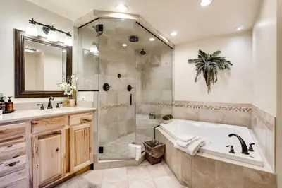 a bathroom with a tub and a shower and a sink at Serene Nordic-Inspired Lakeside Retreat with Panoramic Mountain Views Near Breckenridge, Dillon, Colorado in Dillon