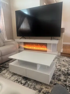 a living room with a tv on top of a fireplace at Iman in DEN