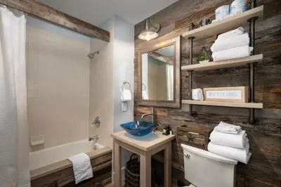 a bathroom with a sink and a toilet and a tub at Premium Unit 2502 - 2BR - Zephyr Mountain Lodge condo in Winter Park