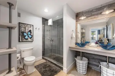 a bathroom with a shower and a toilet and a sink at Premium Unit 2502 - 2BR - Zephyr Mountain Lodge condo in Winter Park