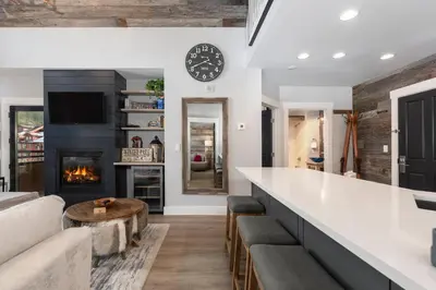 a living room with a bar and a fireplace at Premium Unit 2502 - 2BR - Zephyr Mountain Lodge condo in Winter Park