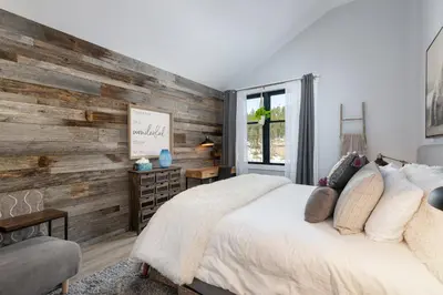 a bedroom with a wooden accent wall and a bed at Premium Unit 2502 - 2BR - Zephyr Mountain Lodge condo in Winter Park