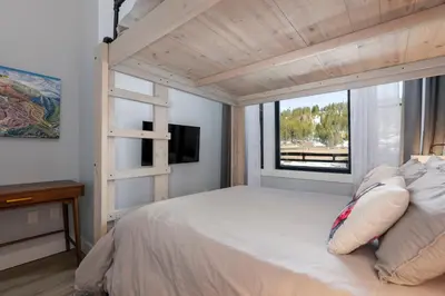 a bedroom with a white bed with a window at Premium Unit 2502 - 2BR - Zephyr Mountain Lodge condo in Winter Park