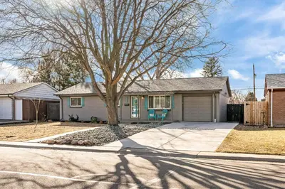 a house with a tree in front of a driveway at Cherry Creek Jasmine Retreat in Denver CO in Denver