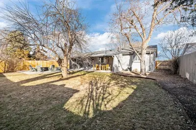 a house with a yard with trees and a fence at Cherry Creek Jasmine Retreat in Denver CO in Denver
