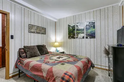 a bedroom with a bed and a tv at Pet-Friendly Pine Home Near Hiking and Fishing! in Pine