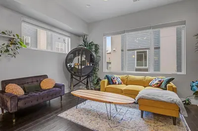 a living room with a yellow couch and a table at Spacious Denver Home with Private Rooftop Spa in Denver