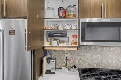 a kitchen with a refrigerator and a microwave at Spacious Denver Home with Private Rooftop Spa in Denver