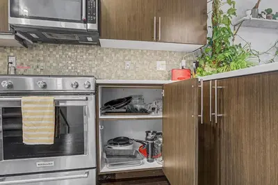 a kitchen with a stainless steel stove and cabinets at Spacious Denver Home with Private Rooftop Spa in Denver