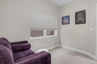 a living room with a purple couch and a window at Spacious Denver Home with Private Rooftop Spa in Denver