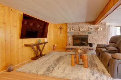 a living room with a couch and a fireplace at Riverfront Drake Home - 10 Mi to Estes Park! in Drake
