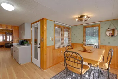 a kitchen and dining room with a table and chairs at Riverfront Drake Home - 10 Mi to Estes Park! in Drake