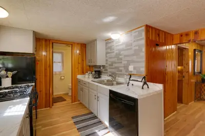 a kitchen with a sink and a stove at Riverfront Drake Home - 10 Mi to Estes Park! in Drake