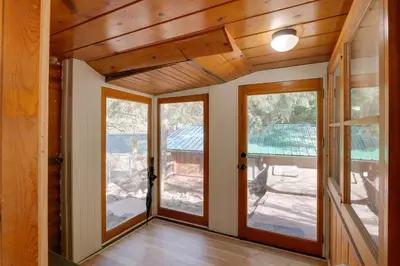 an empty room with two doors and windows at Riverfront Drake Home - 10 Mi to Estes Park! in Drake