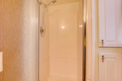 a shower with a glass door in a bathroom at Riverfront Drake Home - 10 Mi to Estes Park! in Drake