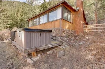 a house on the side of a mountain at Riverfront Drake Home - 10 Mi to Estes Park! in Drake