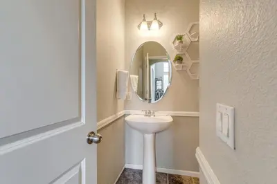 a bathroom with a sink and a mirror at 6 Mi to Buckley Space Force Base Getaway with Patio in Aurora