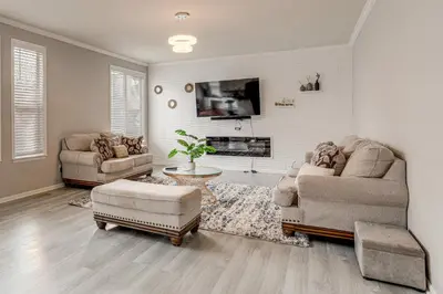a living room with two couches and a tv at 6 Mi to Buckley Space Force Base Getaway with Patio in Aurora