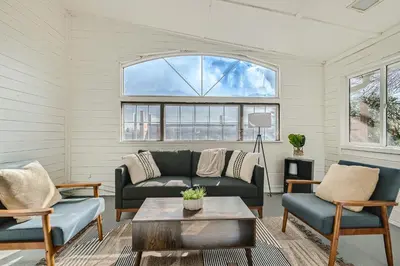 a living room with a couch and a table at Private Home - Hot Tub, Game Room, Fire Pit, Fenced Yard in Westminster