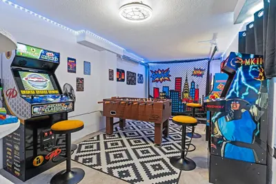 a gaming room with a pinball machine and consoles at Private Home - Hot Tub, Game Room, Fire Pit, Fenced Yard in Westminster