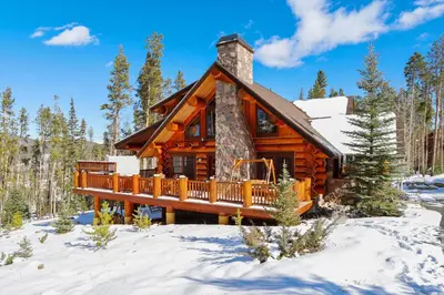 a log cabin in the snow at Experience Fireside Retreat, a comfortable and secluded log home in Breckenridge, Hot Tub in Breckenridge