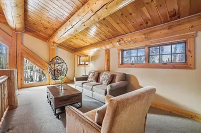 a living room with a couch and a table at Experience Fireside Retreat, a comfortable and secluded log home in Breckenridge, Hot Tub in Breckenridge