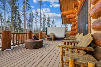 a wooden deck with a bench on a cabin at Experience Fireside Retreat, a comfortable and secluded log home in Breckenridge, Hot Tub in Breckenridge