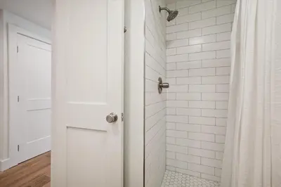 a white bathroom with a shower with a door at Stay at Frisco Creekside Retreat! Located in a great location in Frisco