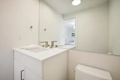 a white bathroom with a sink and a mirror at Stay at Frisco Creekside Retreat! Located in a great location in Frisco