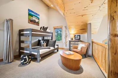 a room with a bunk bed and a table at Experience Frisco Fling, a spacious house in the heart of Frisco with a hot tub and wooded views in Frisco