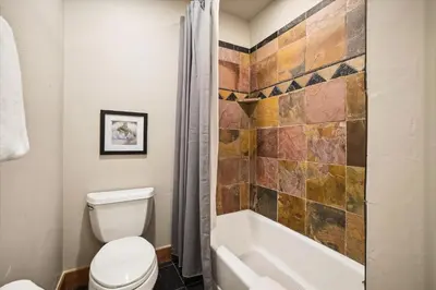 a bathroom with a toilet and a bath tub at Experience Frisco Fling, a spacious house in the heart of Frisco with a hot tub and wooded views in Frisco