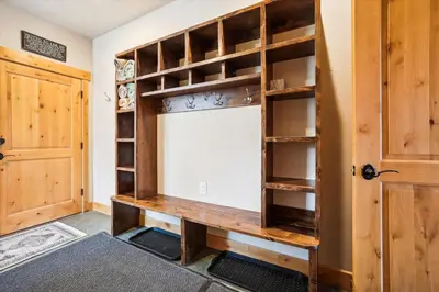 a room with wooden shelves and a door at Experience Frisco Fling, a spacious house in the heart of Frisco with a hot tub and wooded views in Frisco