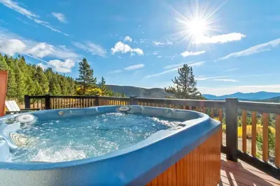 a hot tub on a deck with a view of the mountains at Family Mountain Getaway w Hot Tub and Amazing Views! Close to Hiking & Skiing in Idaho Springs