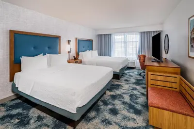 a hotel room with two beds and a flat screen tv at Hampton Inn & Suites Silverthorne in Silverthorne