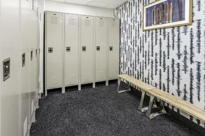 a row of lockers in a locker room with a bench at Hampton Inn & Suites Silverthorne in Silverthorne