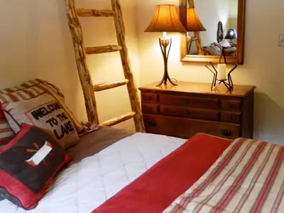 a bedroom with a bed and a dresser with a mirror at The Silver Lake Lodge - Adults Only in Idaho Springs