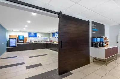 a sliding door in a grocery store with a counter at Holiday Inn Express & Suites Wheat Ridge-Denver West by IHG in Wheat Ridge