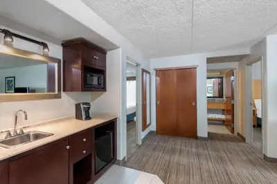 a kitchen with a sink and a counter top at Holiday Inn Express & Suites Wheat Ridge-Denver West by IHG in Wheat Ridge