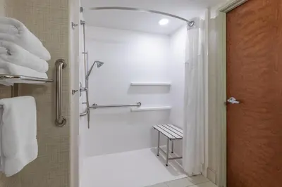 a bathroom with a shower with a shower curtain at Holiday Inn Express & Suites Wheat Ridge-Denver West by IHG in Wheat Ridge