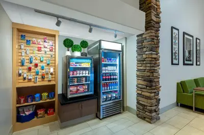 a grocery store with a refrigerator in a room at Holiday Inn Express & Suites Wheat Ridge-Denver West by IHG in Wheat Ridge
