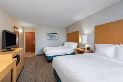 a hotel room with two beds and a flat screen tv at Holiday Inn Express & Suites Wheat Ridge-Denver West by IHG in Wheat Ridge