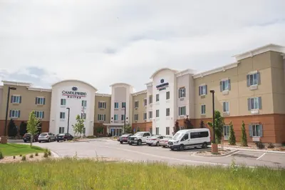 a view of a hotel with cars parked in a parking lot at Candlewood Suites Fort Collins by IHG in Fort Collins