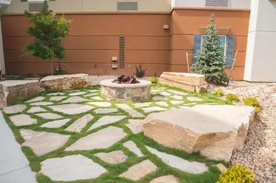 a garden with a fire pit in the middle at Candlewood Suites Fort Collins by IHG in Fort Collins