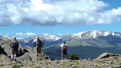 three people standing on the top of a mountain at Hyatt House Denver Lakewood Belmar in Lakewood