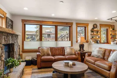 a living room with leather furniture and a fireplace at Mount Victoria Lodge #D in Frisco