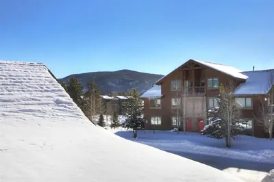 a house with a pile of snow in front of it at Mount Victoria Lodge #D in Frisco